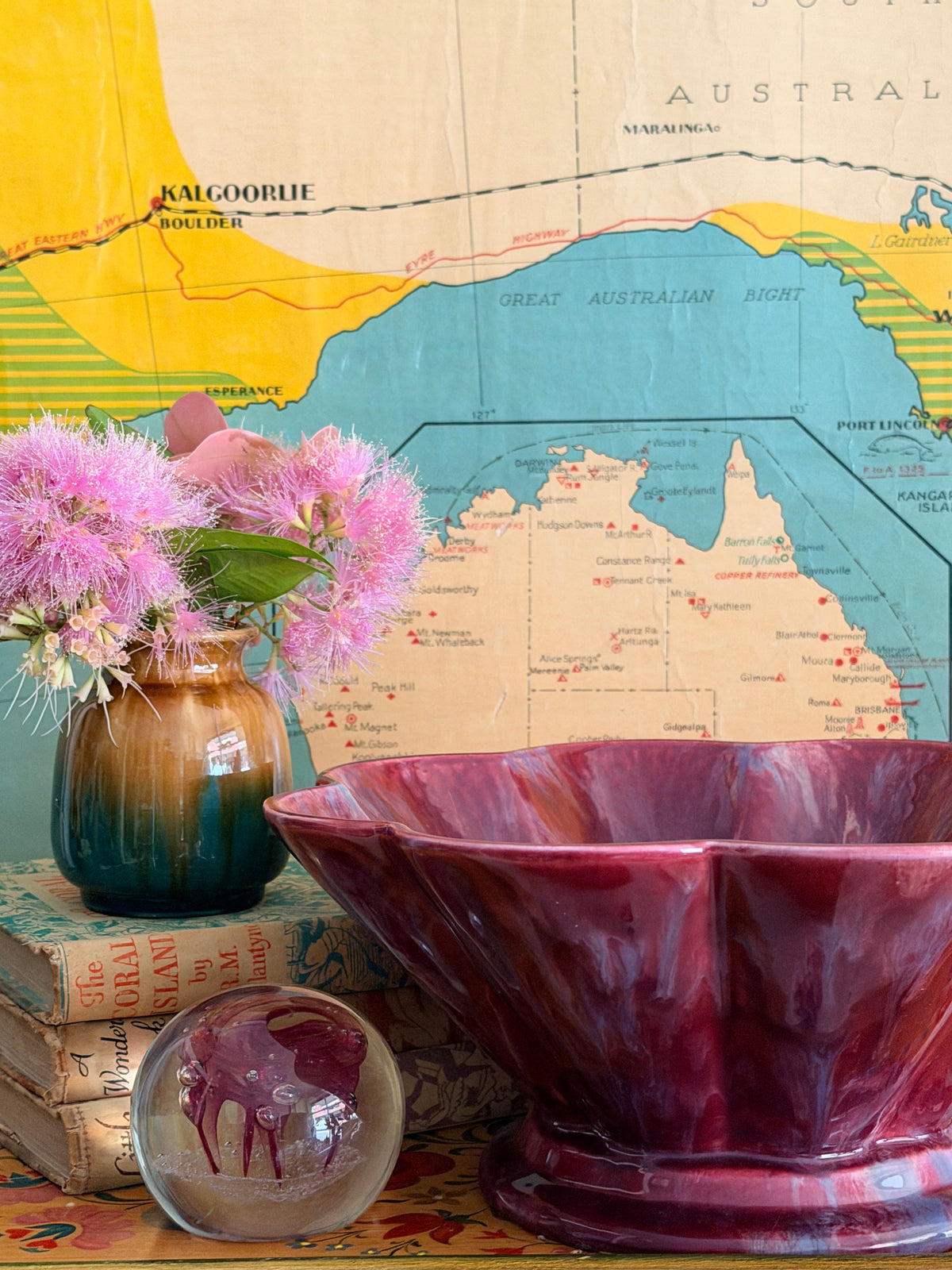 A glossy marbled deep magenta-purple ceramic bowl with a fluted rim.