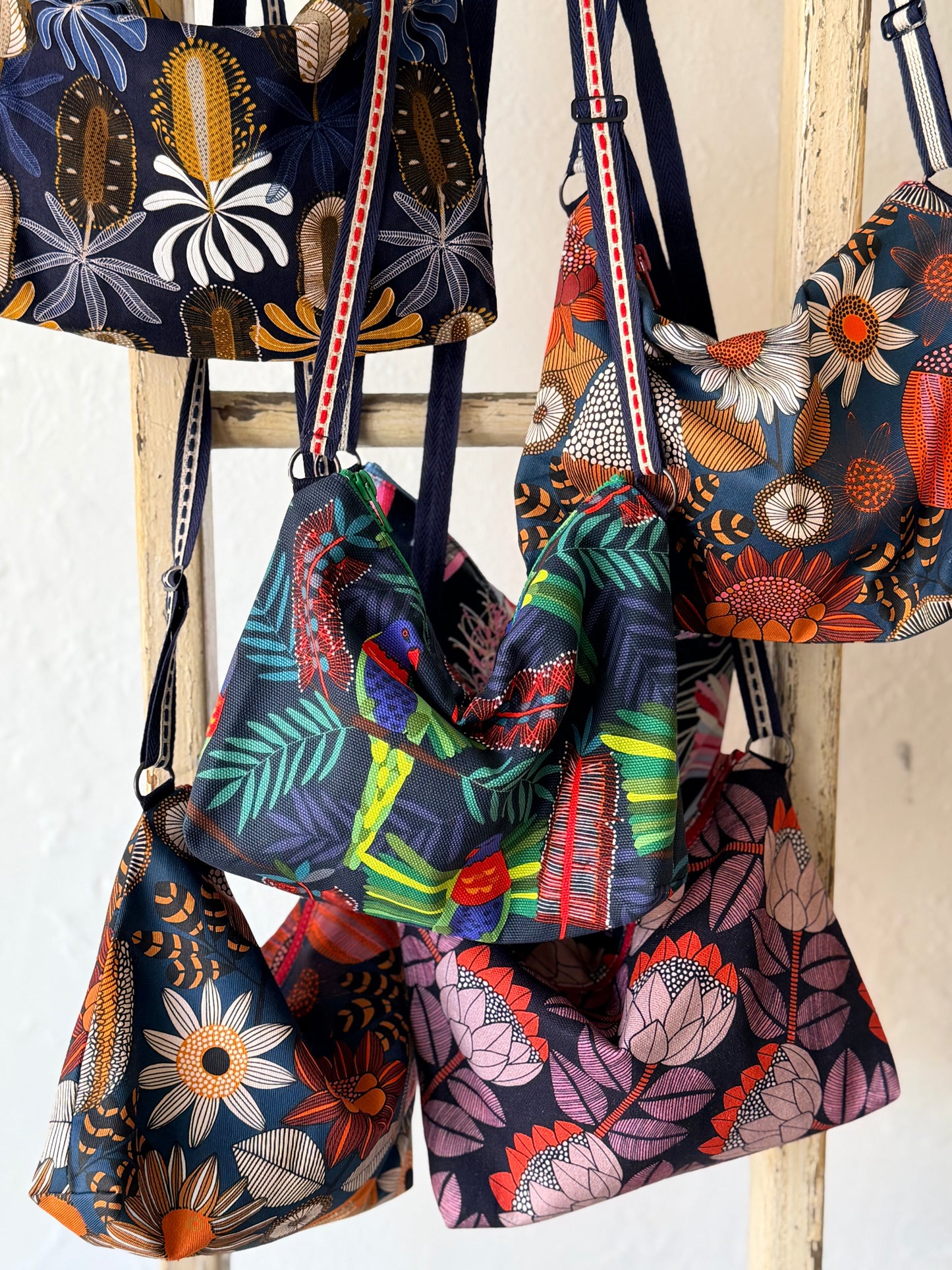 group of australian native print crossbody bags