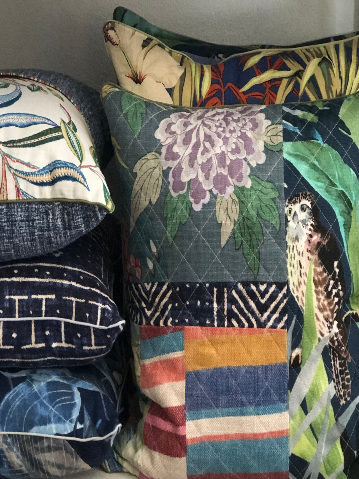 Collection of decorative pillows with various patterns and colors.