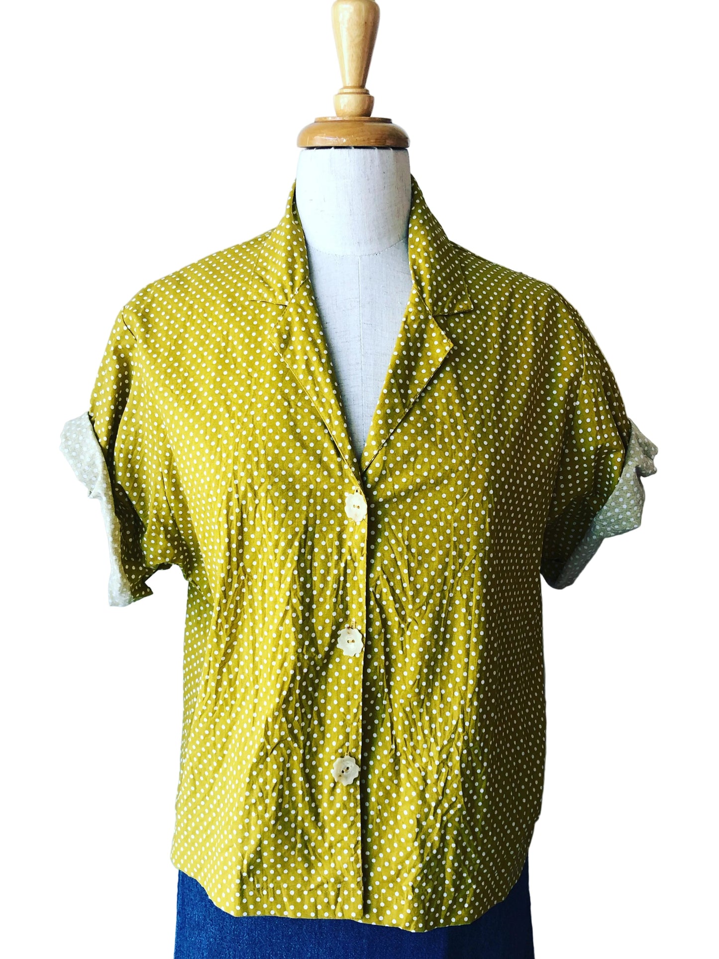 A mustard yellow crop bobby shirt with a polka dot pattern