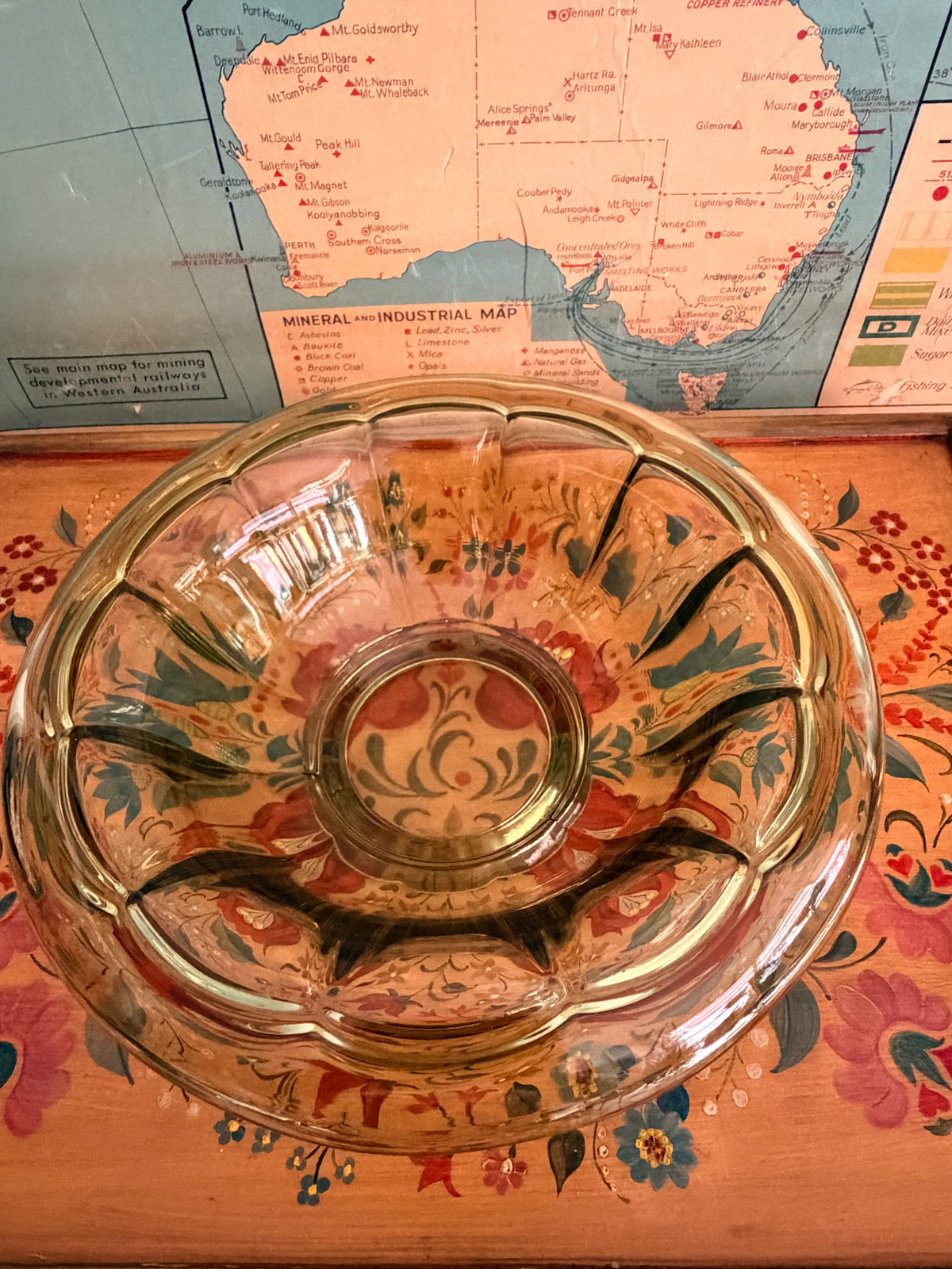 A vintage scalloped glass bowl with a greenish tint