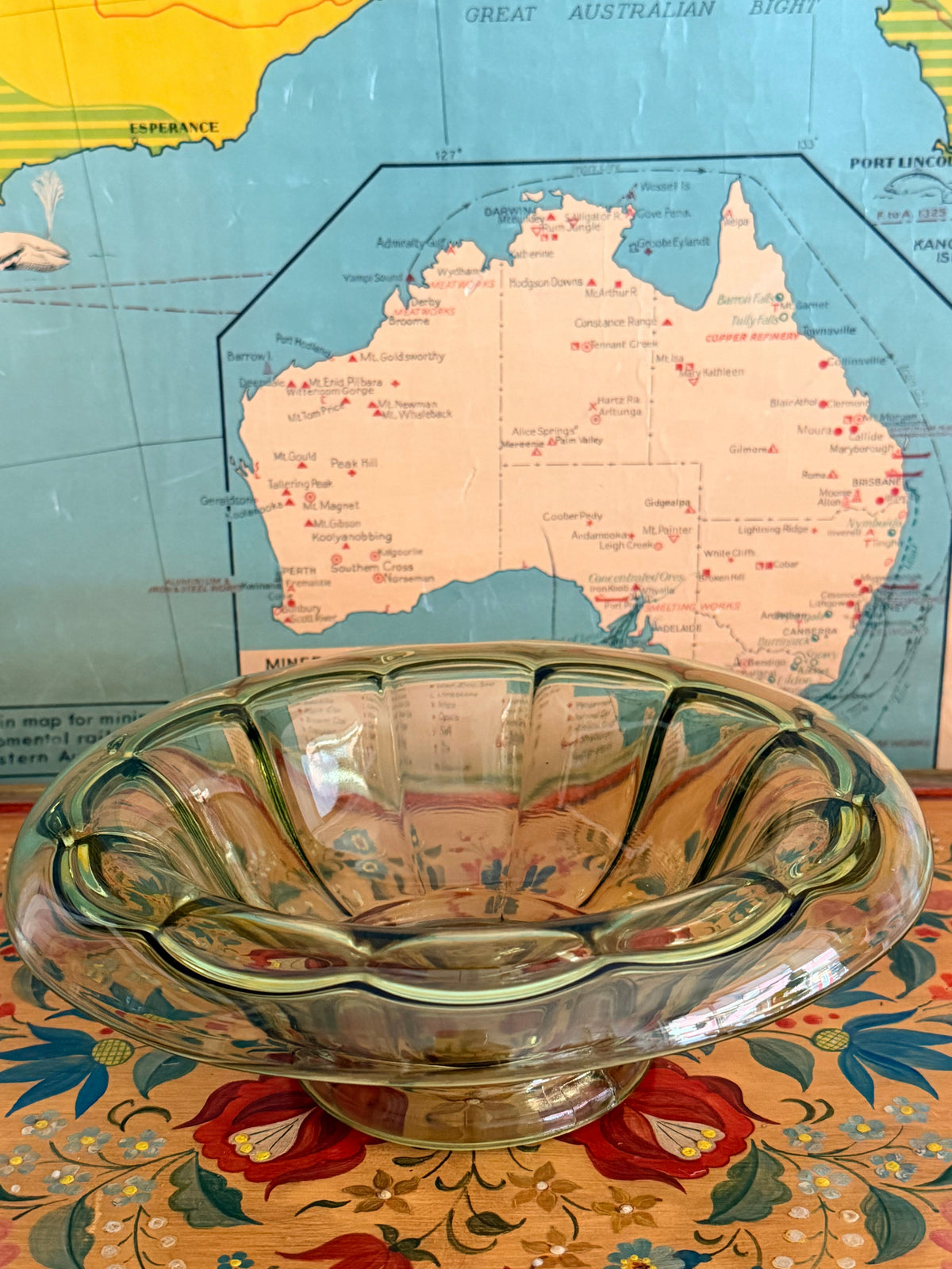 A vintage scalloped glass bowl with a greenish tint