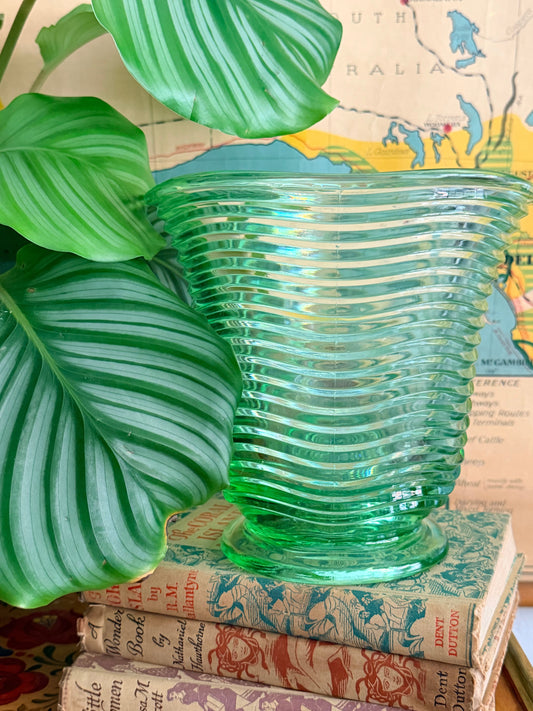A  vintage translucent green ribbed glass vase 