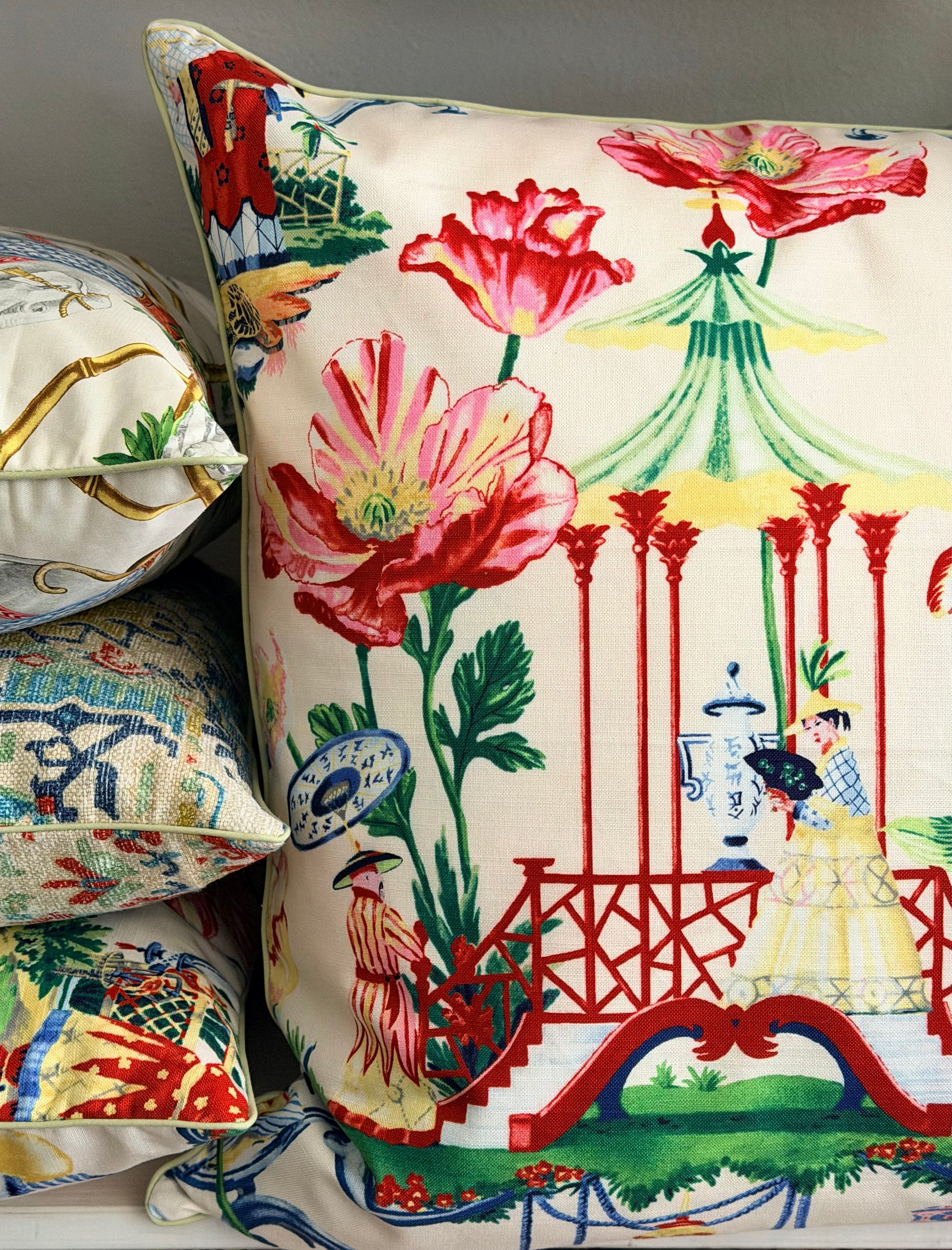 stack of chinoiserie cushions with bold blooms and a pagoda