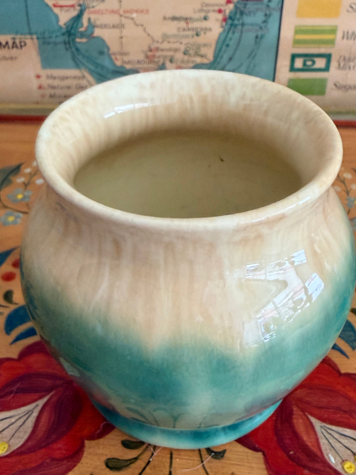 A ceramic Mashman vase with a blue-green and cream gradient glaze 