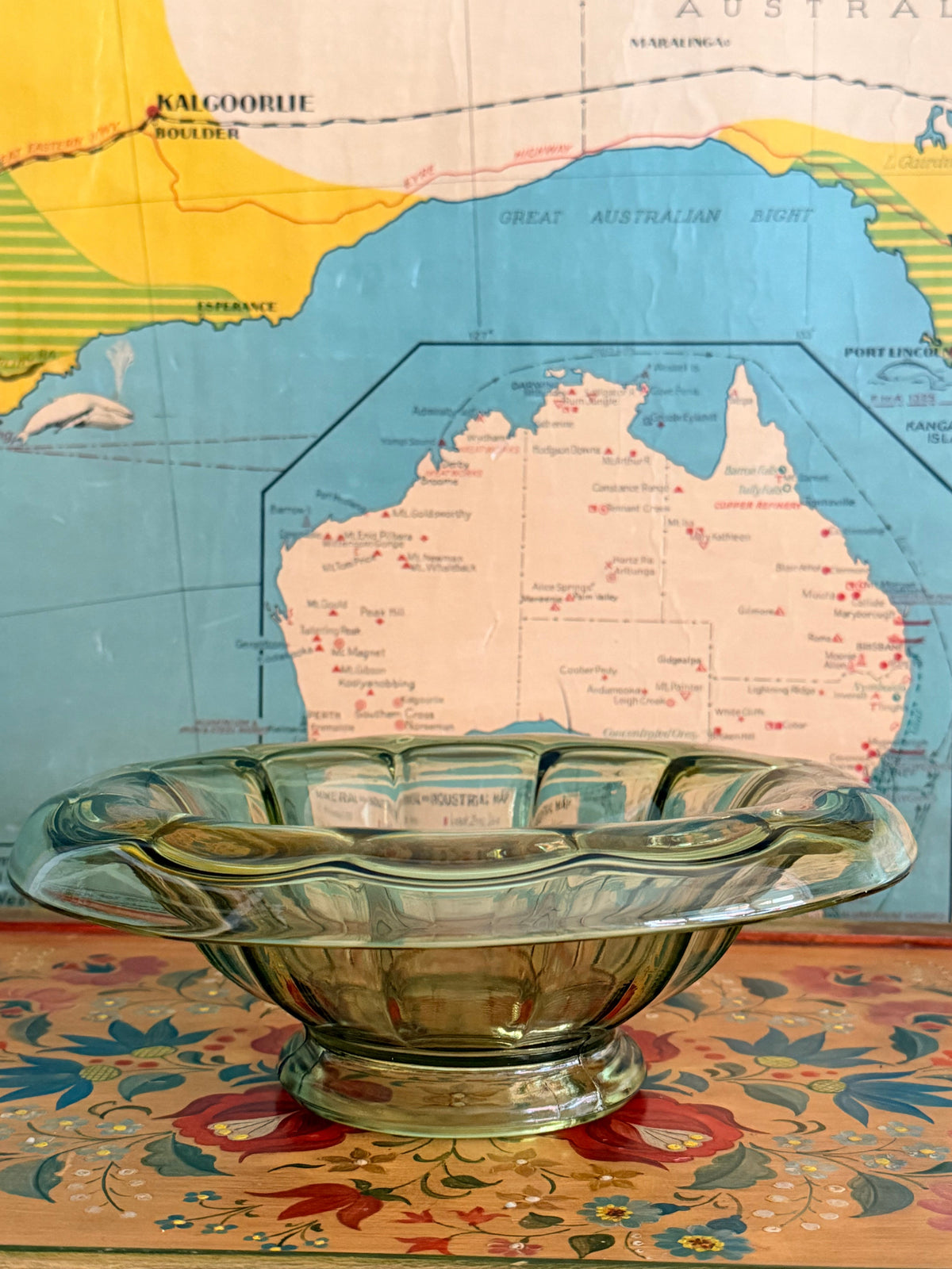 A vintage scalloped glass bowl with a greenish tint