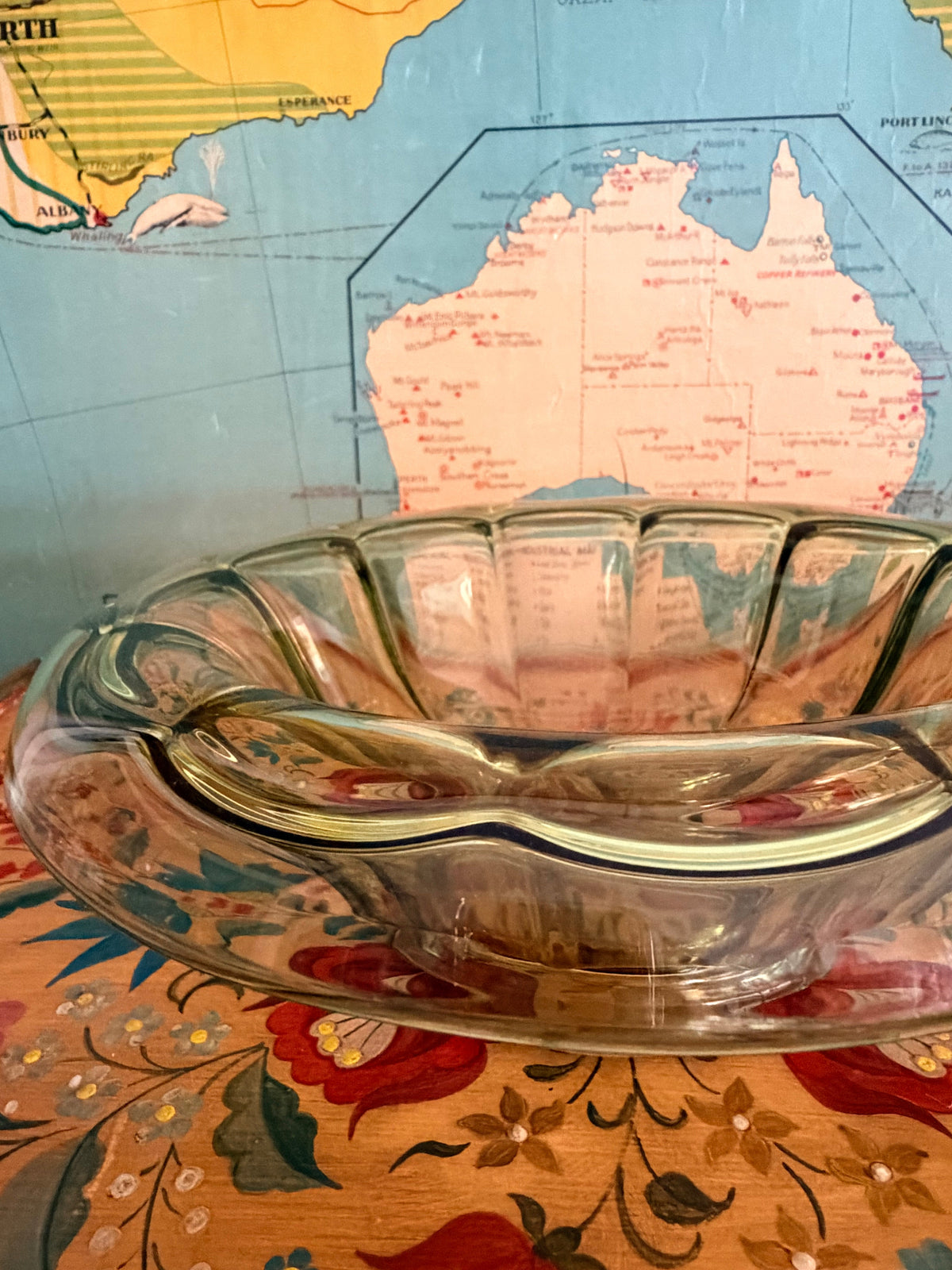 A vintage scalloped glass bowl with a greenish tint