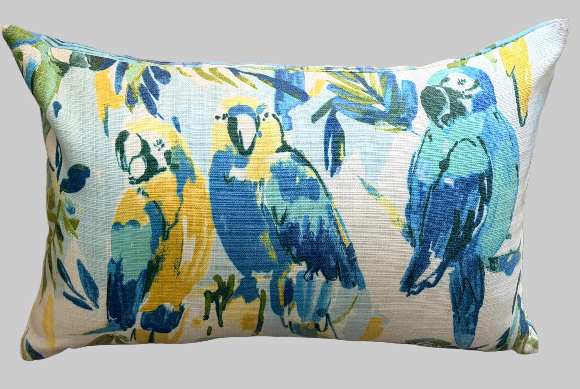 Decorative pillow with parrot pattern on a textured surface