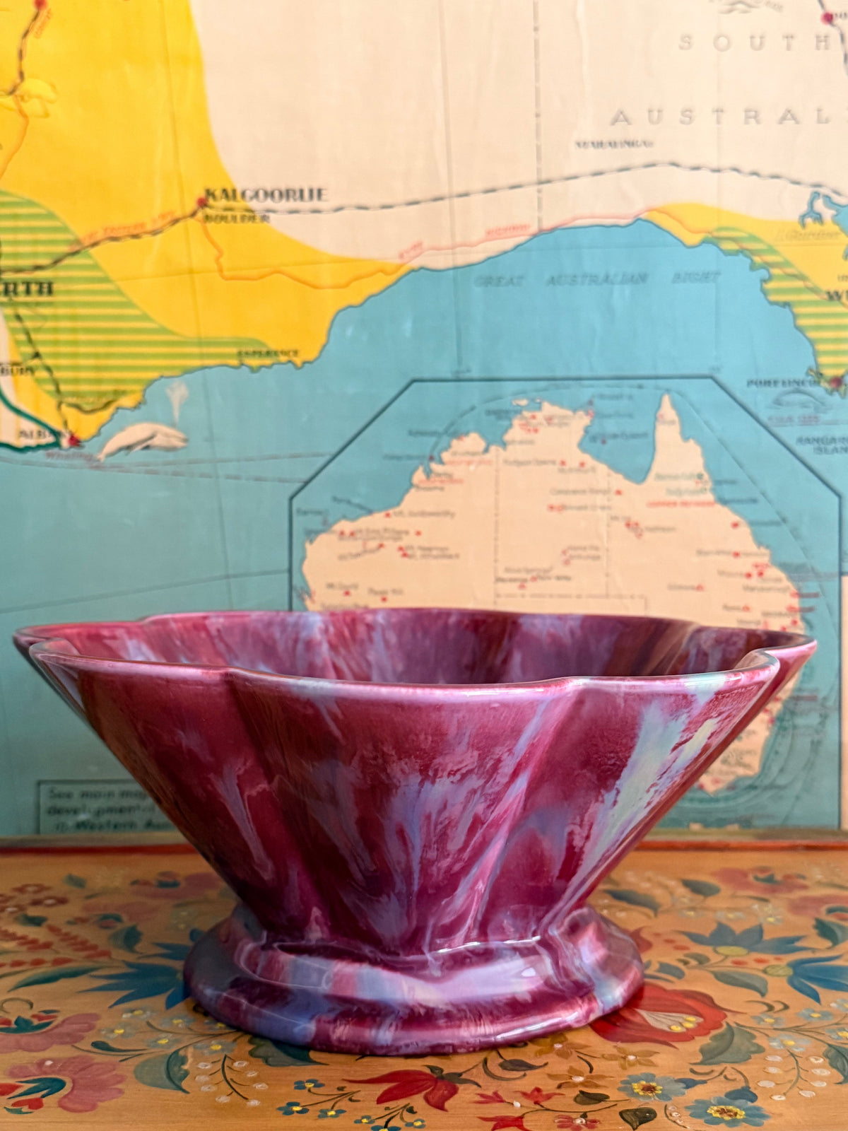 A glossy marbled deep magenta-purple ceramic bowl with a fluted rim.