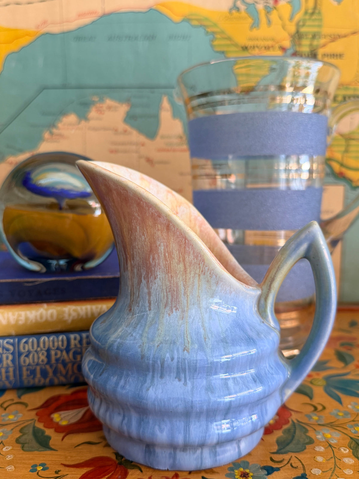A small  art deco newtone art ware ceramic pitcher with a blue and beige marbled drip glaze