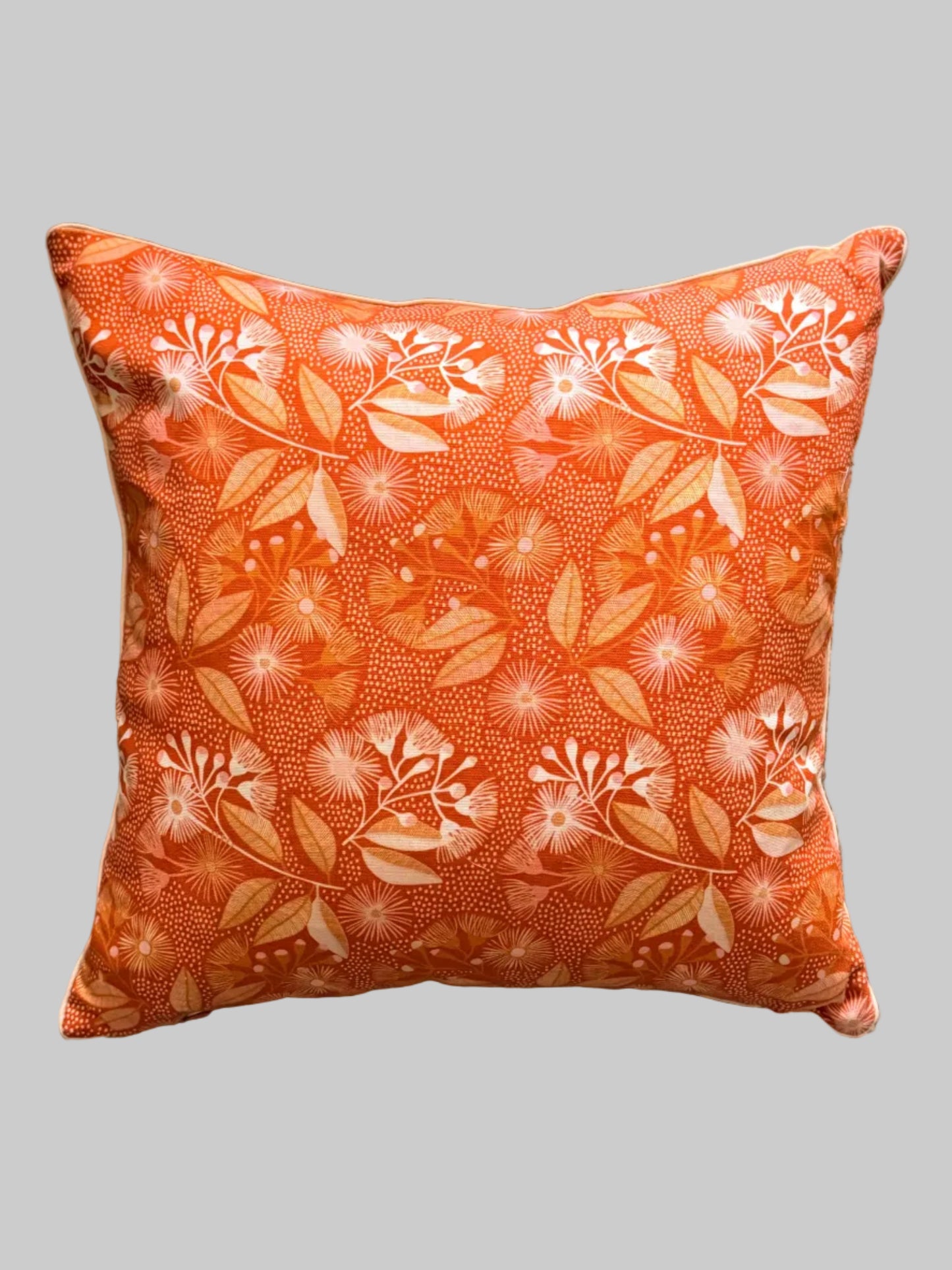 Decorative pillow with burnt orange flowering gum