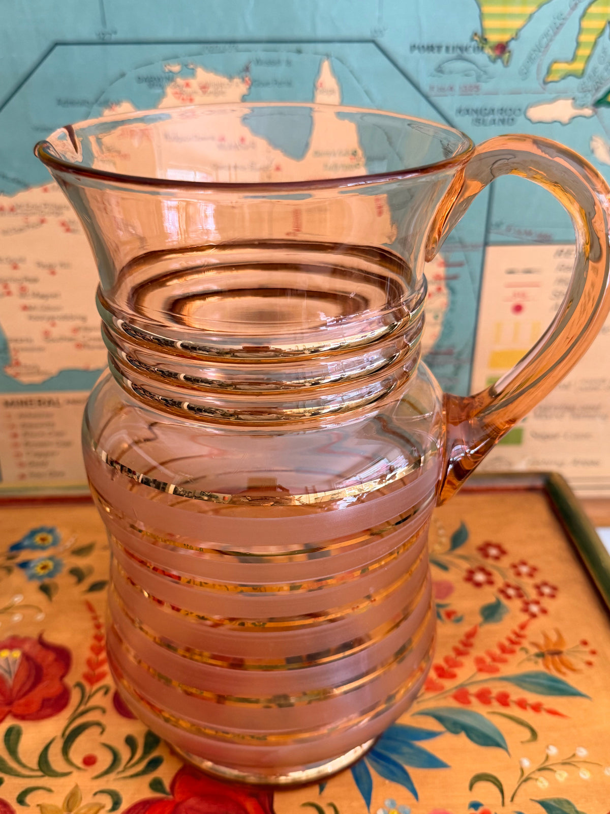 A group of retro vintage aqua blue glass tumblers with etched grape designs and bright blue bases,