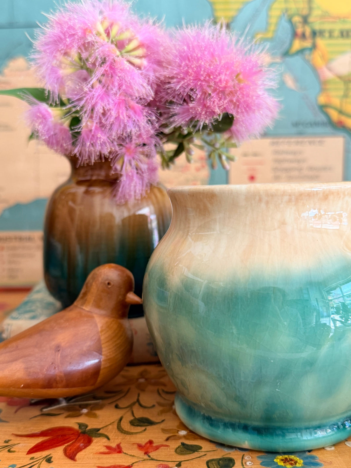 A ceramic deco vase with a blue-green and cream gradient glaze 