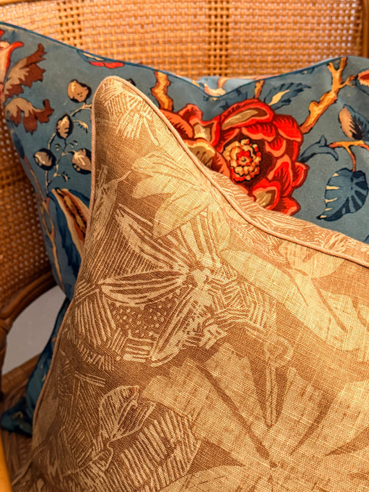 Close-up of decorative pillows with floral patterns on a textured surface.
