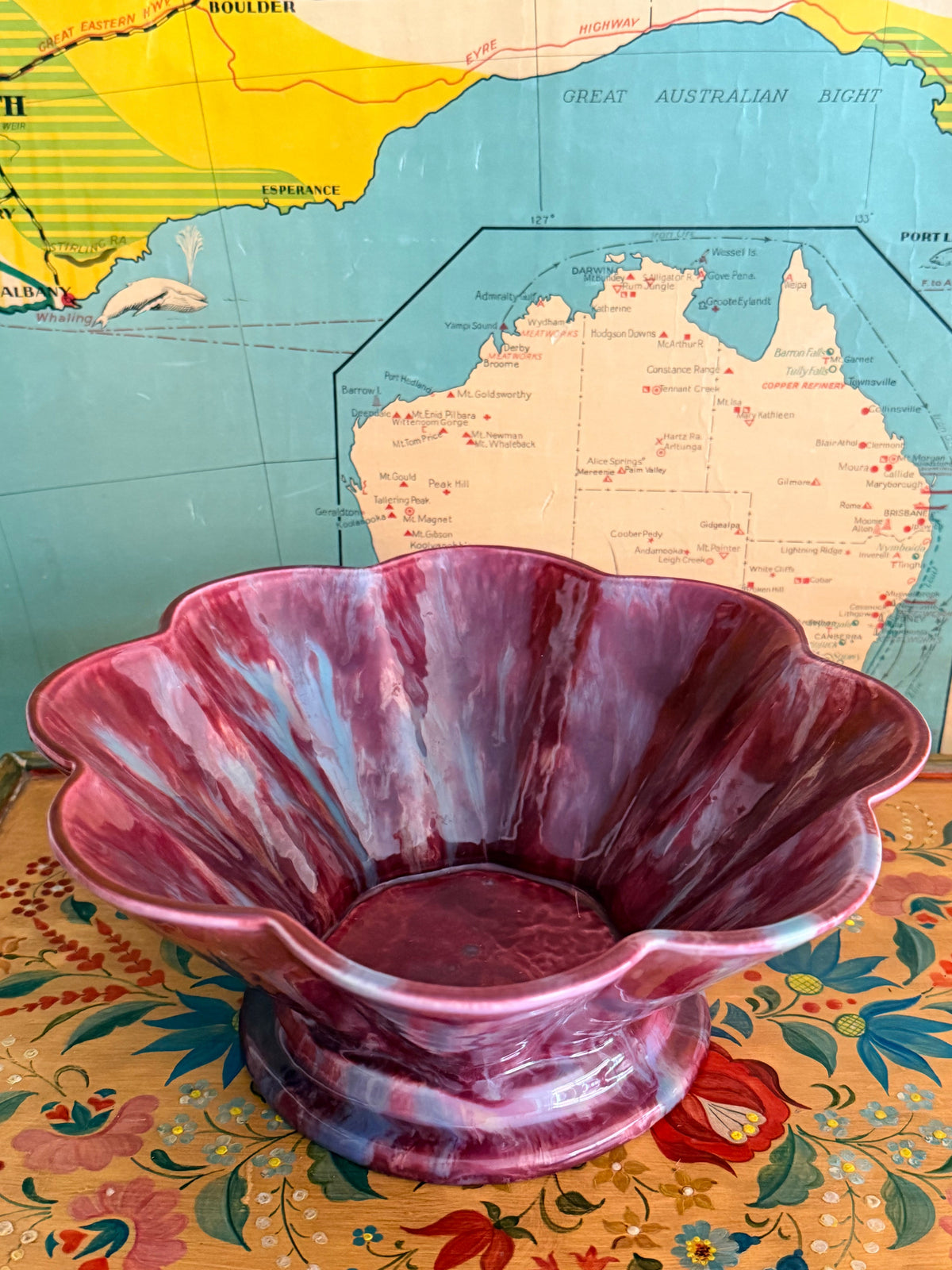 A glossy marbled deep magenta-purple ceramic bowl with a fluted rim.