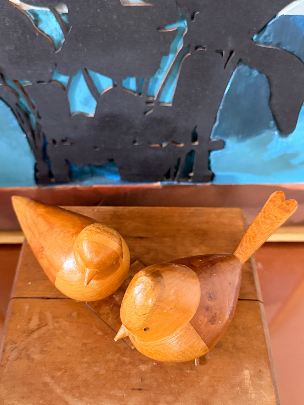 Two small carved wooden scandi retro birds with metallic wire legs.