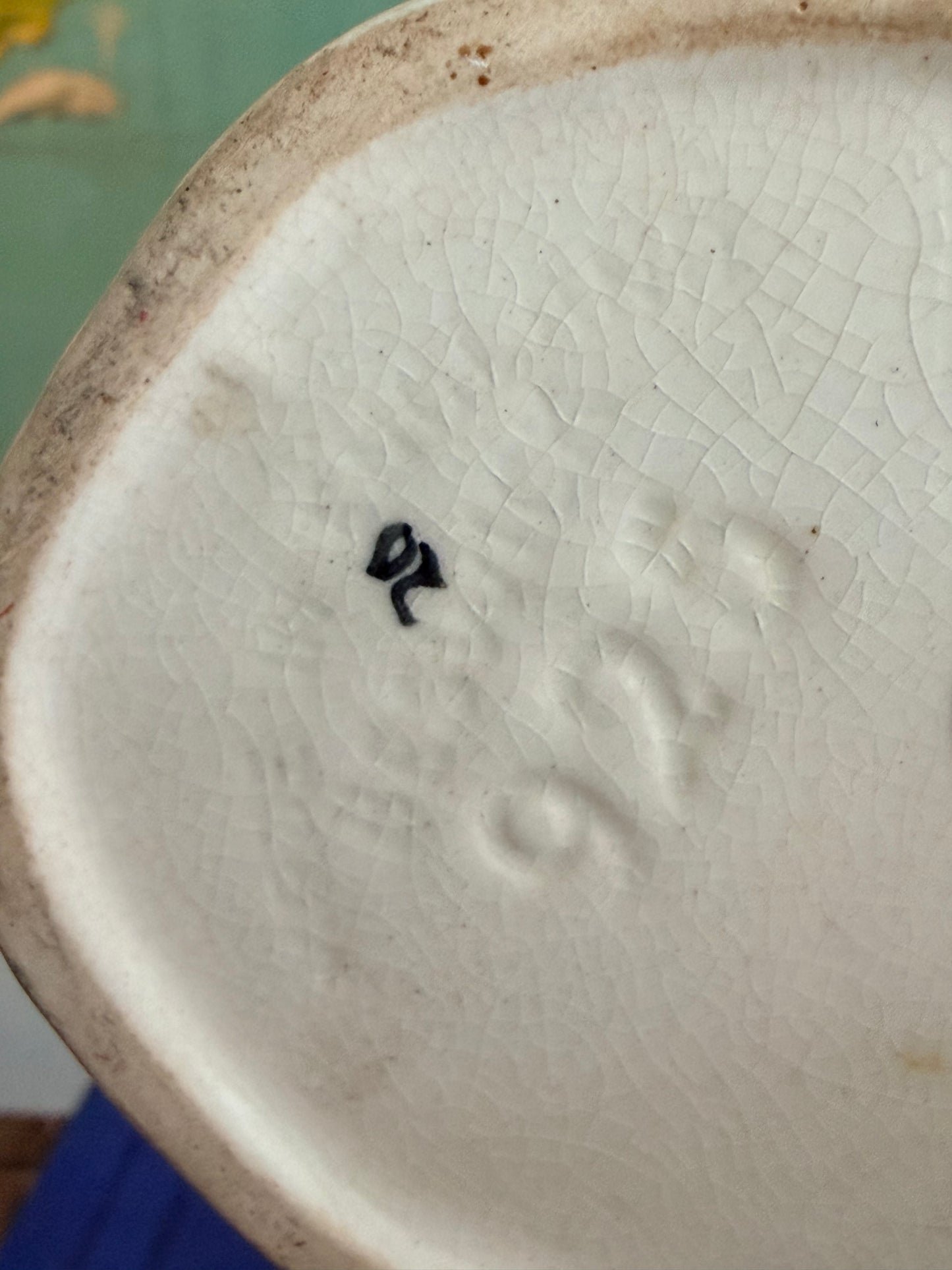 Close-up of a ceramic object with a visible brand logo on a blurred background