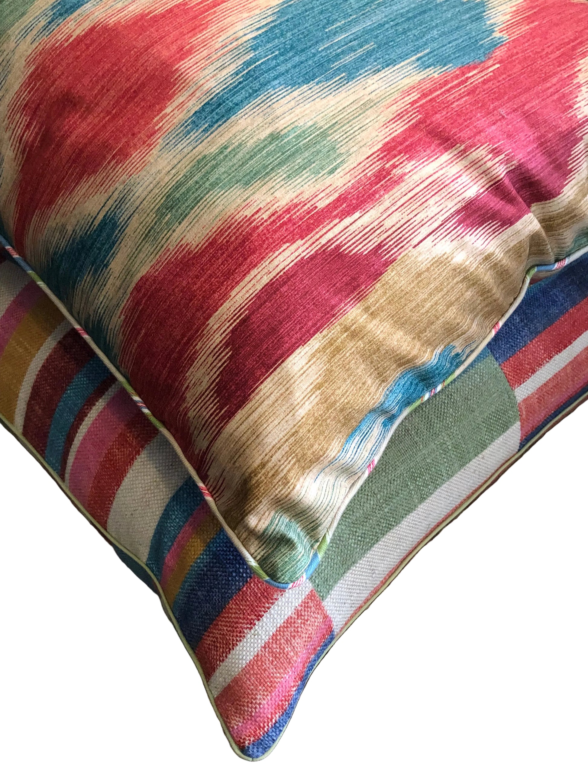 stack of carnival ikat piped cushion