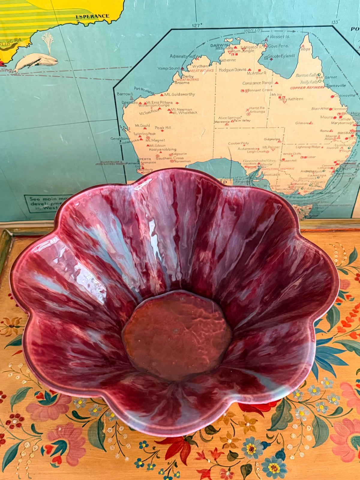A glossy marbled deep magenta-purple ceramic bowl with a fluted rim.