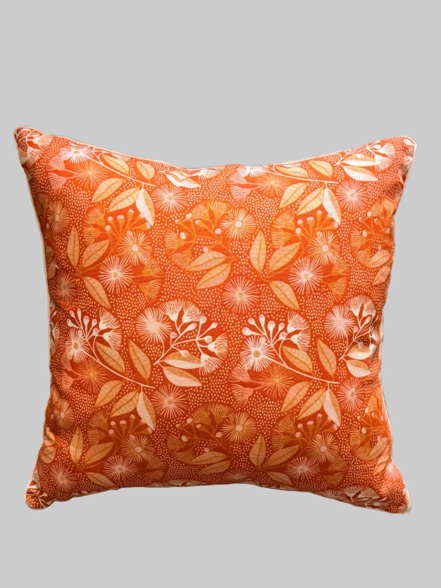 Decorative pillow with burnt orange flowering gum